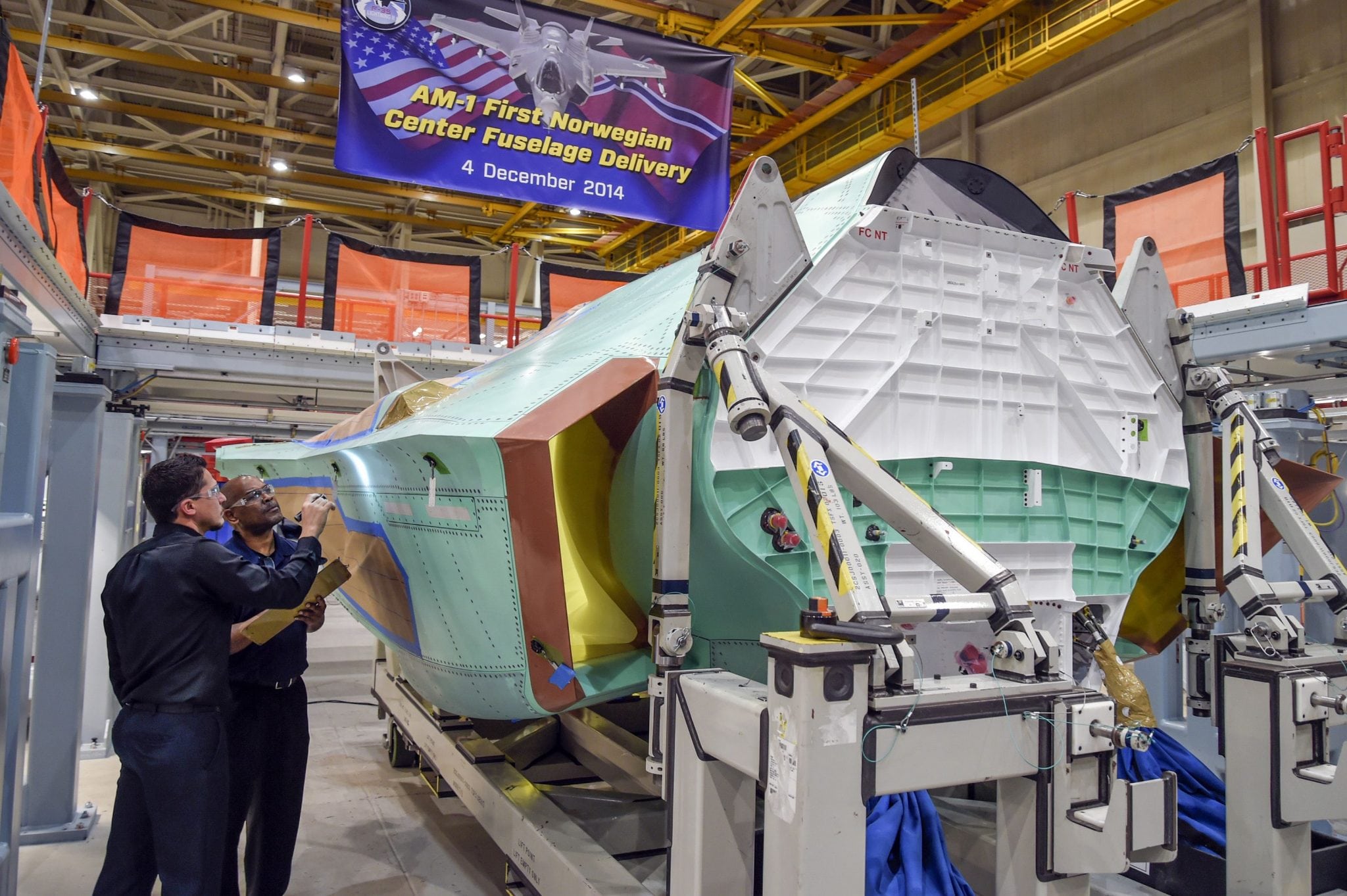 Technicians at Northrop Grumman's Palmdale (Calif.) Aircraft Integration Center of Excellence conduct final quality inspections on the center fuselage for AM-1