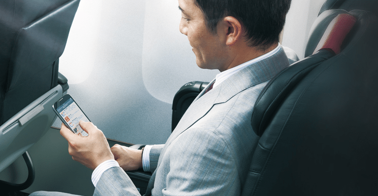 JAL passenger using Wi-Fi in flight on a smartphone