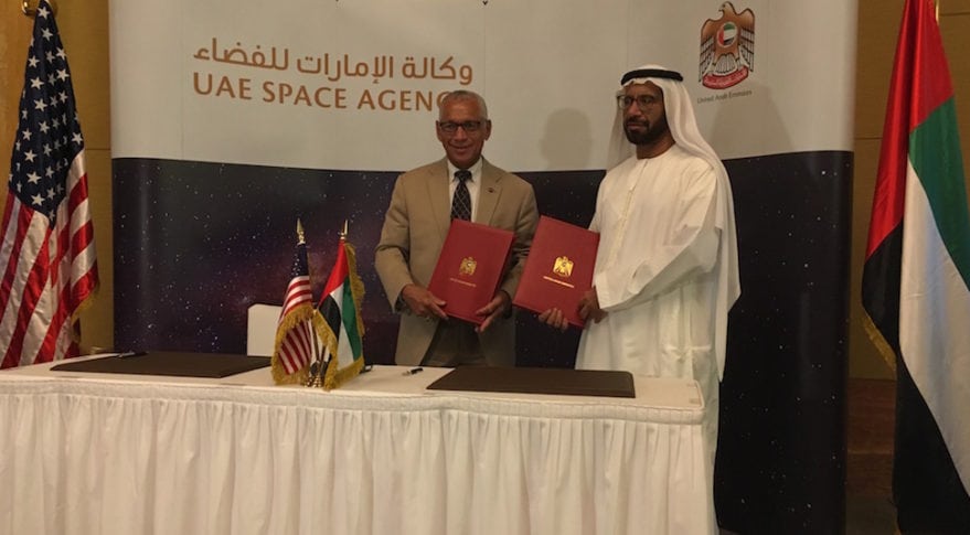 UAE Space Agency Chairman Khalifa Al Romaithi and NASA Administrator Charles Bolden pose with collaborative agreement for aeronautics, space exploration