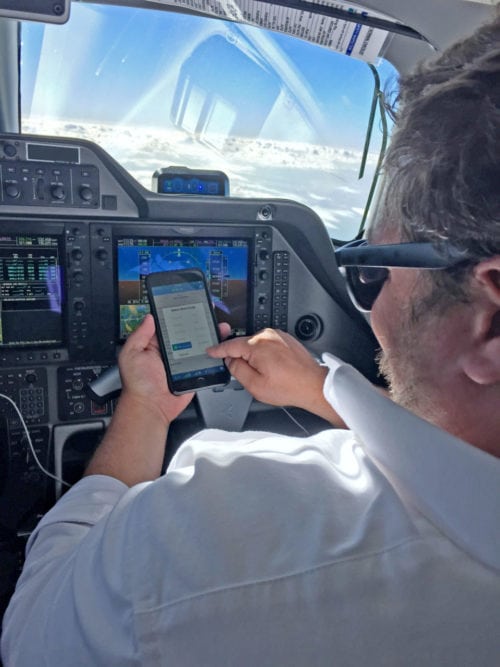 Crewmember using Blue Sky Network in cockpit. Photo: Blue Sky Network.