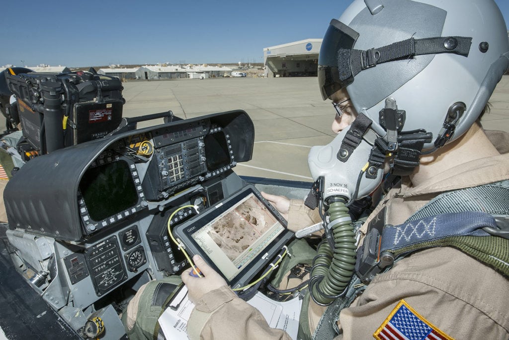 Flight Test Engineer Jacob Schaefer inspects the Cockpit Interactive Sonic Boom Display Avionics, or CISBoomDA, from the cockpit of his F-18 at NASA’s Armstrong Flight Research Center in Edwards, California. Credits: NASA Photo / Ken Ulbrich