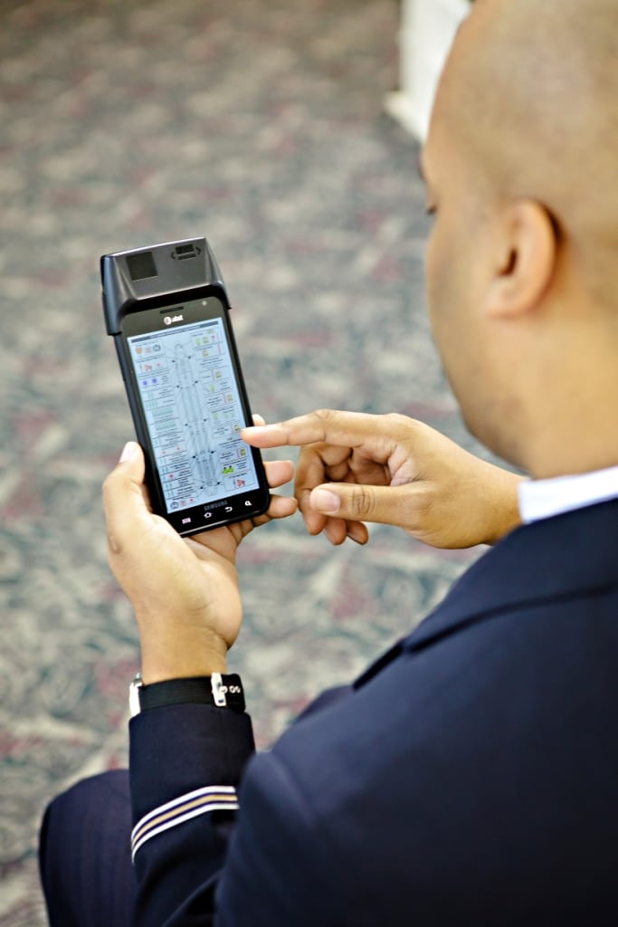 A flight attendant using an electronic manual