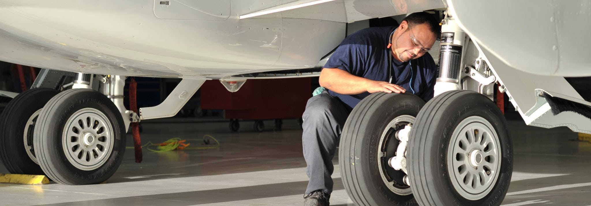 Technician working on Bombardier aircraft at an MRO facility