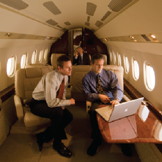 Business passengers on laptop. Photo: Gogo