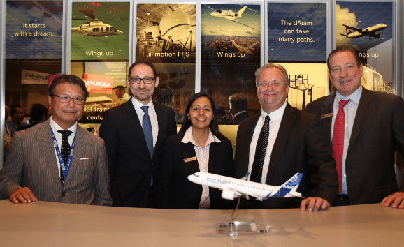 Company executives finalize agreement during 2015 World Aviation Training Symposium in Orlando