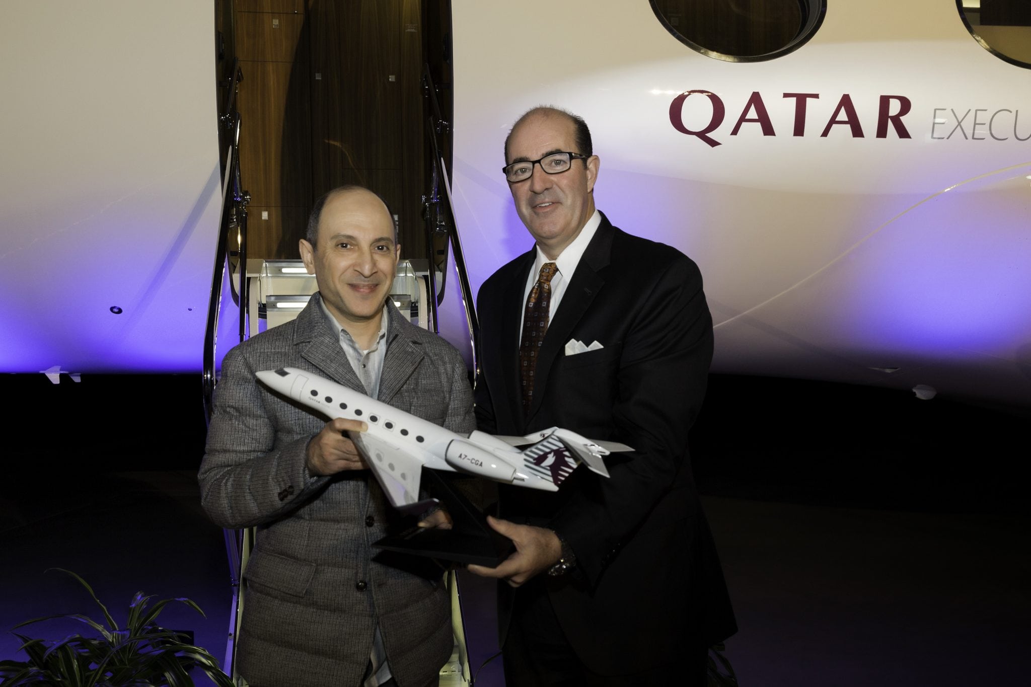 Qatar Airways Group Chief Executive Akbar Al Baker receives an aircraft model from Mark Burns, president, Gulfstream