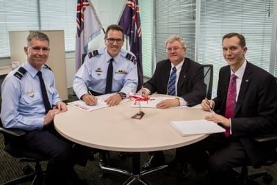 Royal Australian Air Force's Air Commodore Adam Brown, Air Vice-Marshal Leigh Gordon, AM, CSM and Lockheed Martin Australia representatives, Raydon Gates and Jon Rambeau sign the Australian Pilot Training System contract