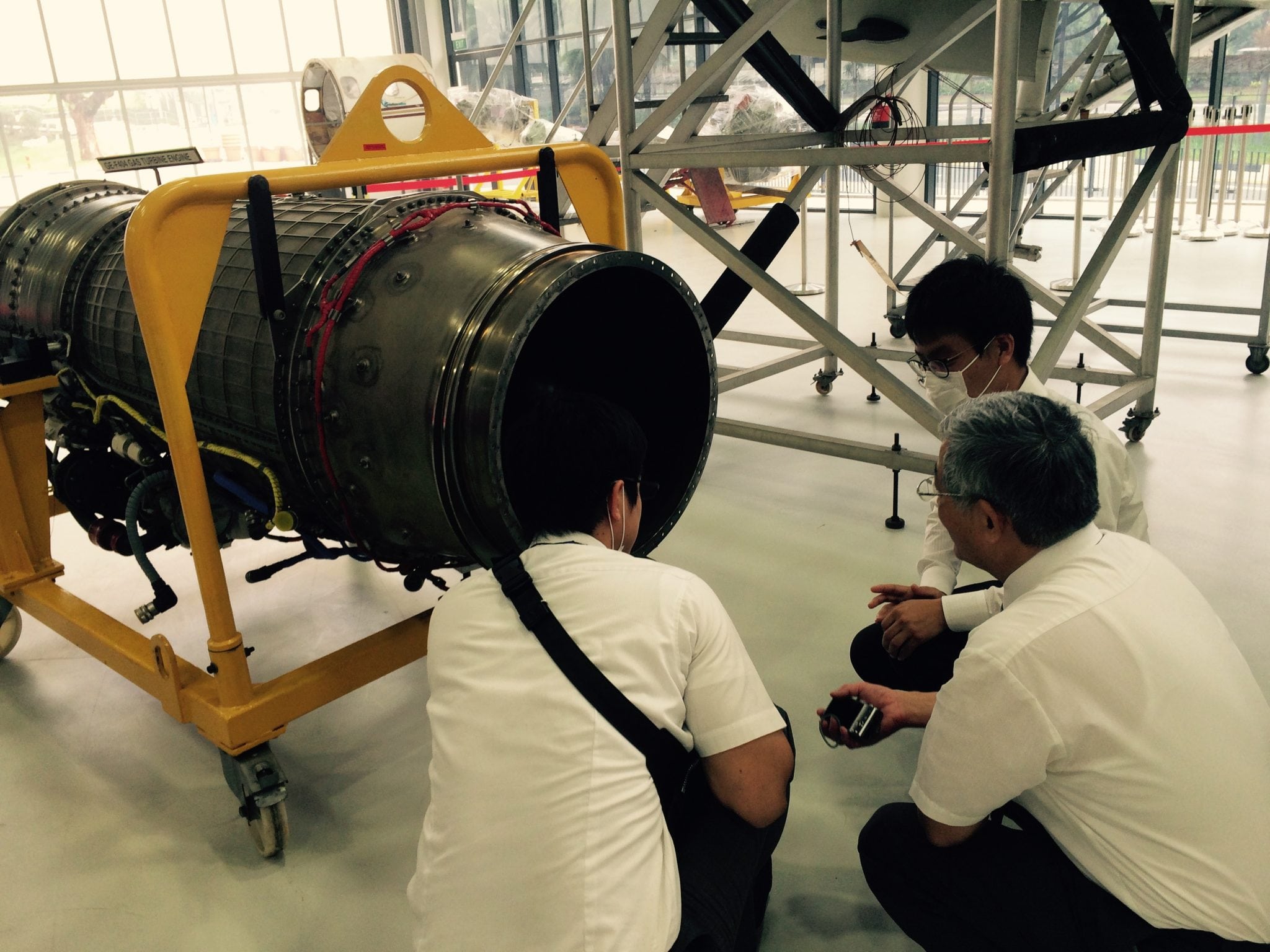 Students studying an aircraft part at the Singapore Polytechnic AeroHub