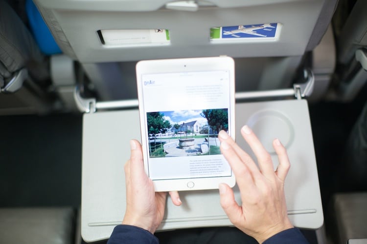 Passenger using personal electronic device to view in-flight entertainment with AirFi