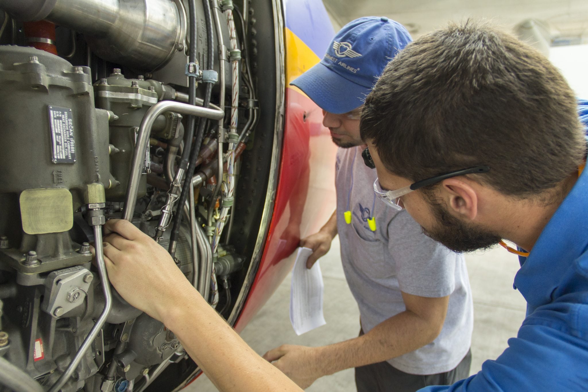 Technicians work on an aircraft