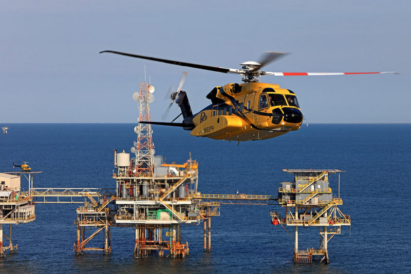 A PHI Sikorsky S-92A cruises past an oil rig in the Gulf of Mexico. Photo: Lockheed Martin.