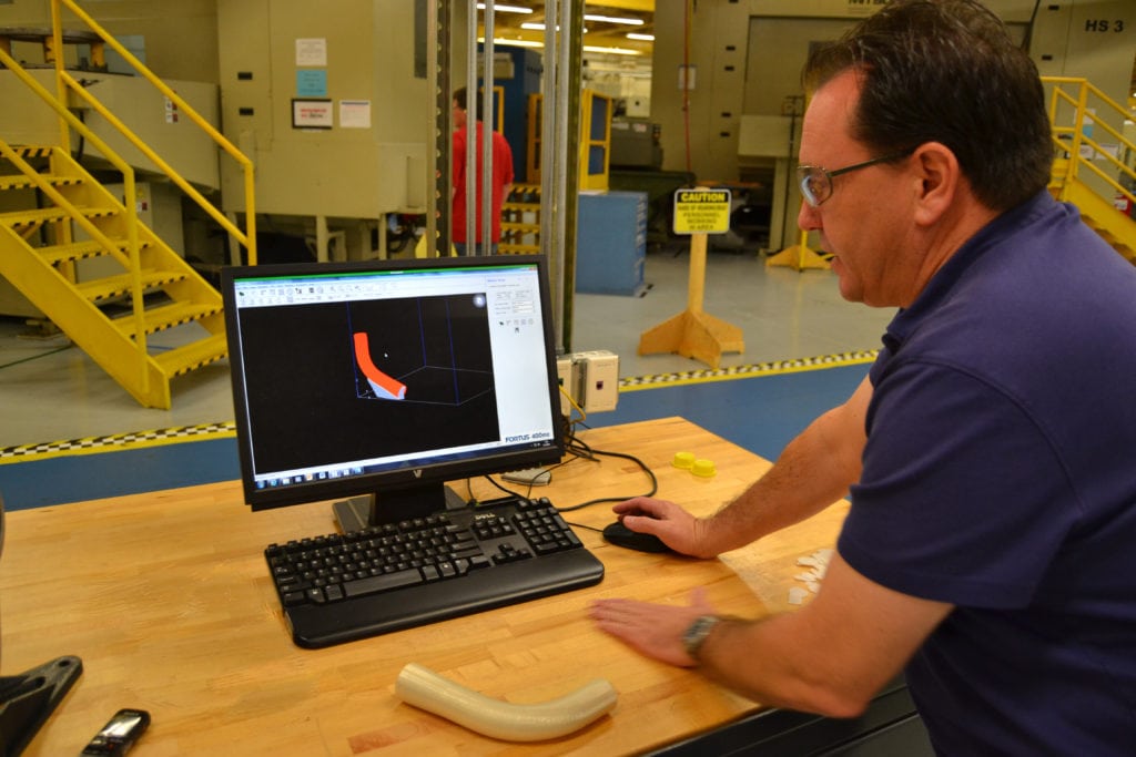 170202-N-LQ867-001 JACKSONVILLE, Fla. (Feb. 2, 2017) Randy Meeker, an Fleet Readiness Center Southeast tooling designer, shows how a piece of environmental duct for a T-44 Pegasus was designed and created with a 3D printer in the facility's manufacturing department. (U.S. Navy photo by Clifford Davis/Released)
