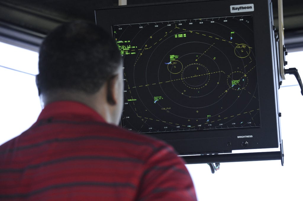 Kevin Griffith, 4th Operations Support Squadron air traffic controller, monitors airspace surrounding the base from the air traffic control tower March 9, 2015, at Seymour Johnson Air Force Base, North Carolina. Tower personnel monitoring airspace are responsible for an area approximately five miles wide and a half-mile high.. (U.S. Air Force photo/Airman 1st Class Aaron J. Jenne)