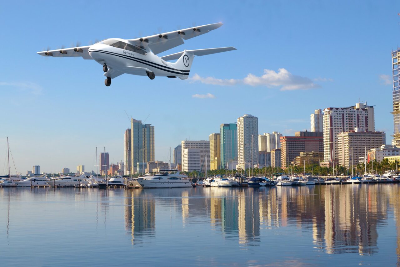 an electra hybrid estol aircraft in yugo livery approaches a landing near manila bay