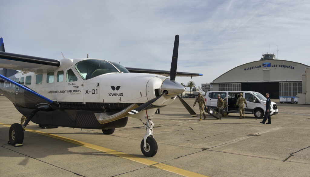 Airmen load weather equipment into Xwing's autonomous Cessna 208B Grand Caravan during AGILE FLAG 24-1 at McClellan Airfield in Sacramento, California, Jan. 27, 2024. The cargo was delivered to March Air Reserve Base, California, and was the second autonomous logistics mission during an Air Force exercise. Xwing's autonomous flight technology allows its aircraft to taxi, takeoff, fly to a destination, avoid airborne and ground threats, and land, without any human input. AFWERX has awarded Xwing two Small Business Innovation Research contracts, a Phase Two in March 2023 and a Phase Three in December 2023 to demonstrate the capability in an operationally relevant environment. (U.S. Air Force photo by Matthew Clouse)