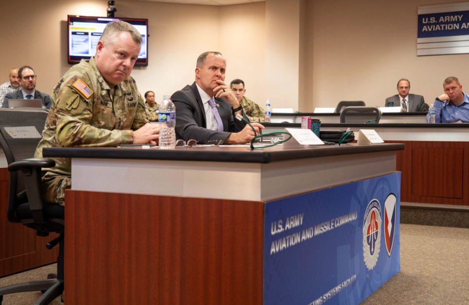 Lt. Gen. Chris Mohan, Army Materiel Command commanding general, and Rich Martin, AMC director of supply chain management, listen to a presentation during the AMC Advanced Manufacturing Summit, December 4, 2025. U.S. Army photo by Lindsay Grant, AMC public and congressional affairs office.