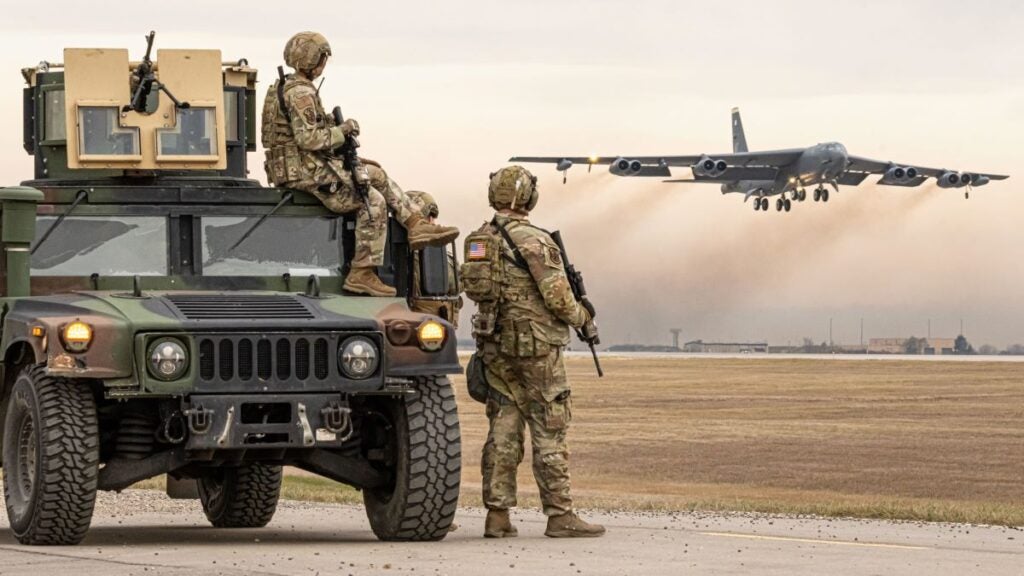 Pictured is a U.S. Air Force photo of personnel with the 5th Security Forces Squadron at Minot AFB, N.D. on Oct. 26, 2025, as they watch a B-52H bomber take off during the Global Thunder 26 exercise.