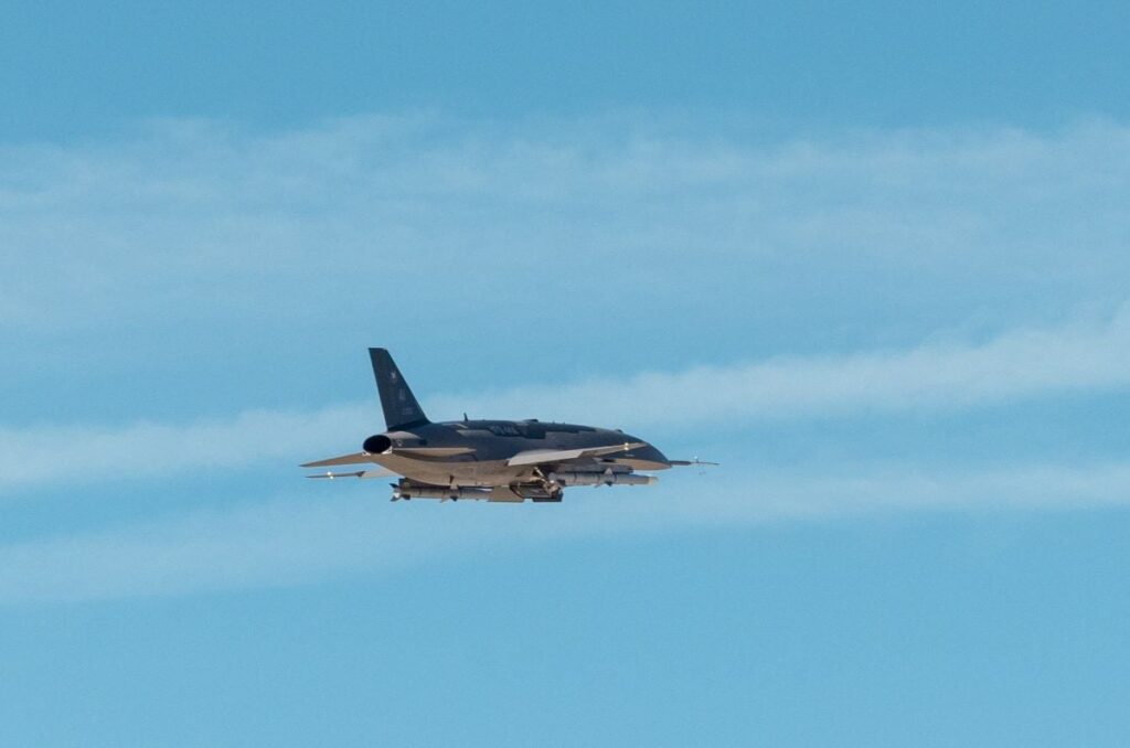 Pictured is a U.S. Air Force photo of an Anduril Industries YFQ-44A flying over Edwards AFB, Calif. during a test by Air Combat Command's Experimental Operations Unit.