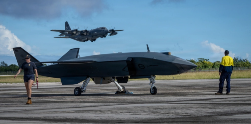 Pictured is a U.S. Air Force photo of an HC-130J Combat King II with the 79th Rescue Squadron taking off behind an MQ-28 Ghost Bat, a production representative test aircraft by Boeing Defence Australia, during Exercise Valiant Shield 2026 at Rota, Commonwealth of the Northern Mariana Islands, on June 21.